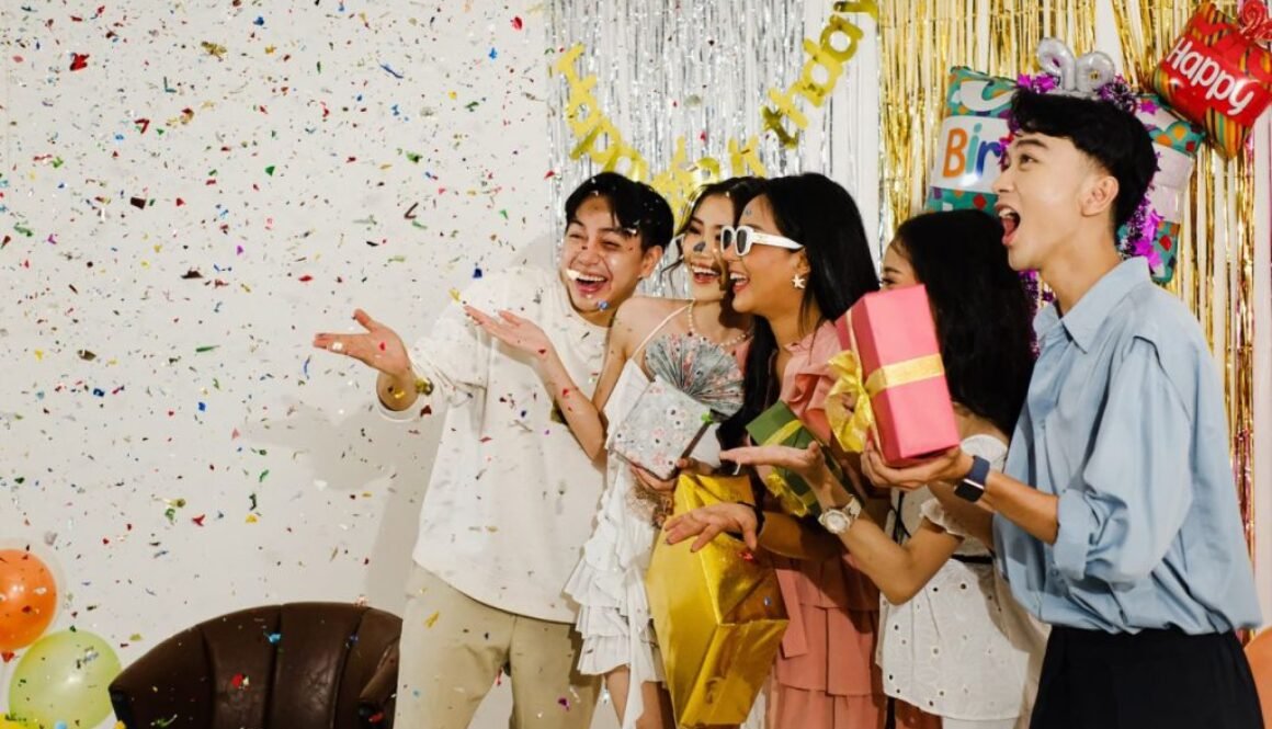 A lively birthday party with friends enjoying confetti and exchanging gifts. Perfect for celebration themes.